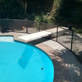 diving board thru pool fence