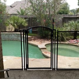 curved gate entrance to swim pool fence